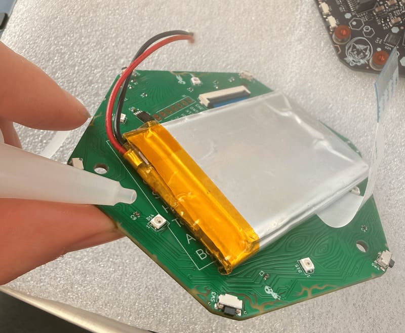 Applying isopropyl to the battery glue dots