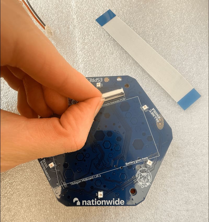Lift the flap of the display connector